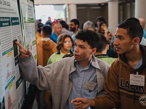 Students discussing a data display board.